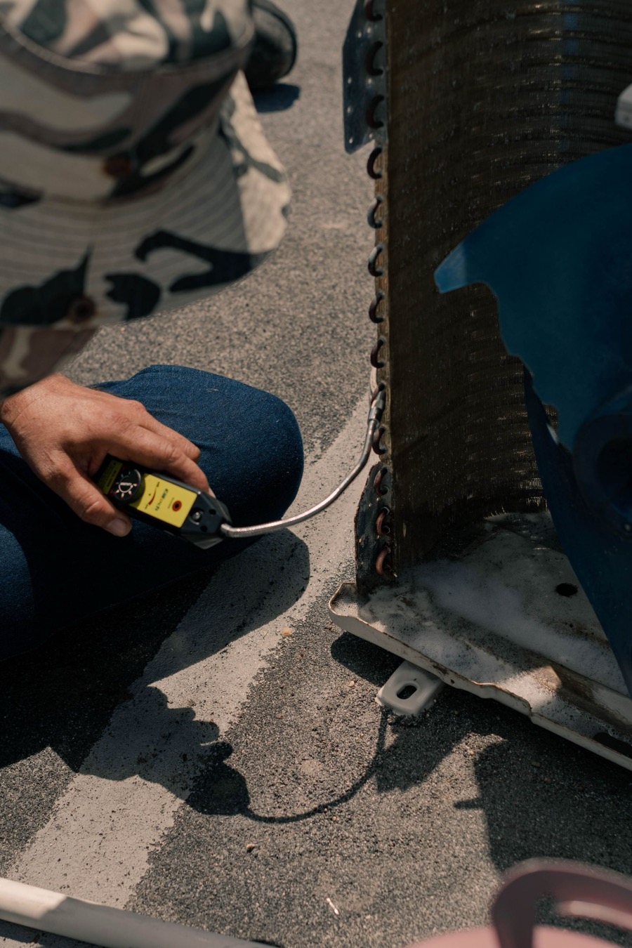 Warren Mechanical technician running refrigerant leak detection on an AC unit