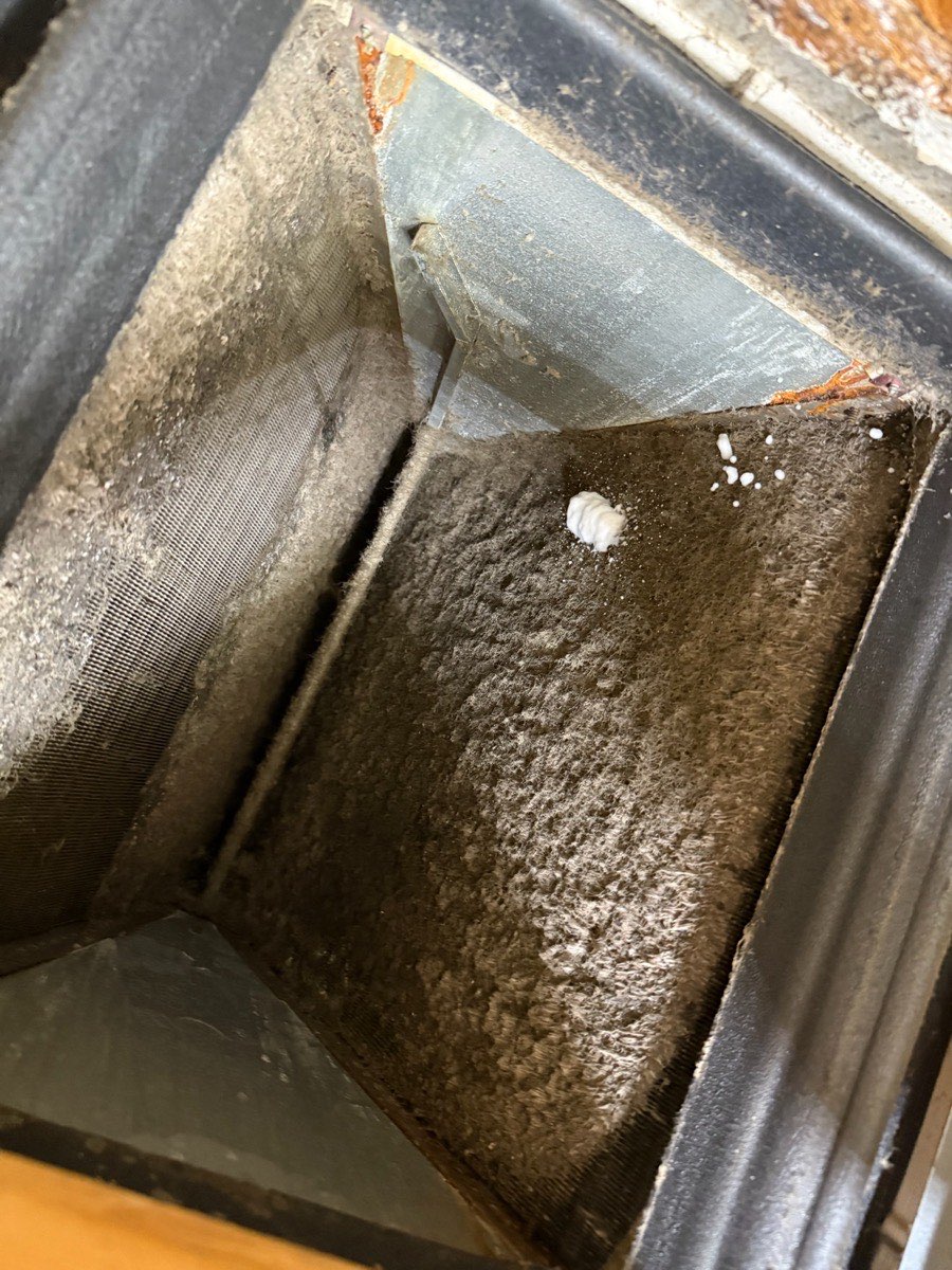 Dust buildup inside a home air duct before cleaning